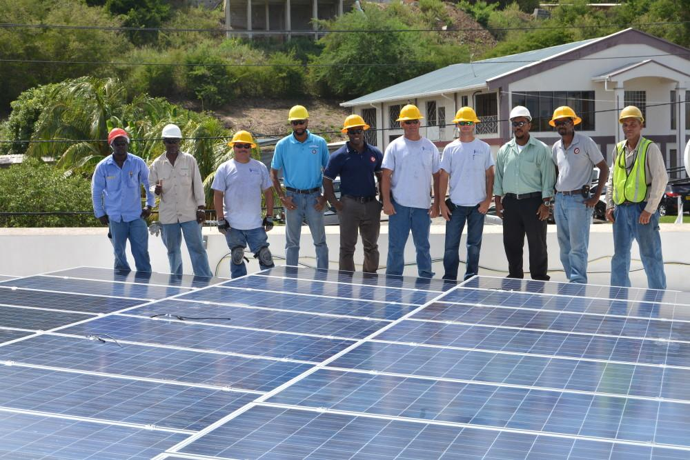Solar workers standing by panels